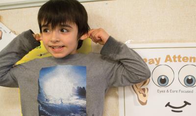 A young boy models "paying attention."