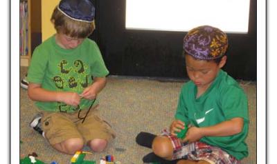 Two boys playing with blocks on floor