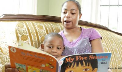 Mother reading a children's book to toddler son