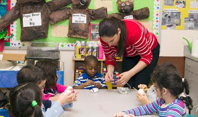 A small group of children engages in an art project