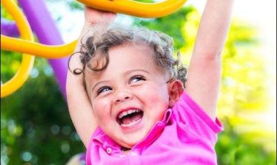 Child playing on outdoor rings.