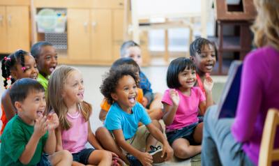 Preschool children sitting in circle for story time 