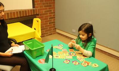 Teacher guiding student with STEM game