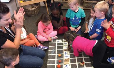 Teacher and preschoolers playing coding games