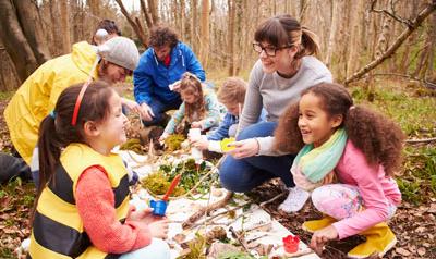 Children and adults working together to learn about the environment