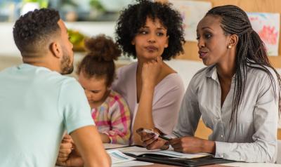 A teacher meets with a family