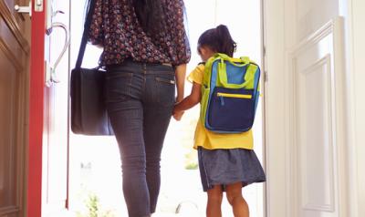 Mom and daughter walking into school holding hands