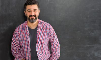 Man in front of chalk board