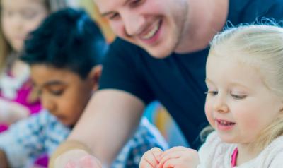 A teacher engages with a child