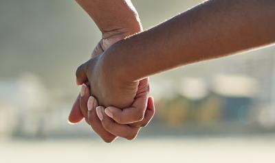 Adult and child hands together