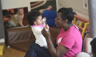 Black early childhood educator with young child