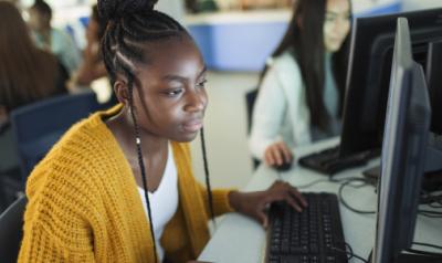 Higher Education student at a computer in a classroom