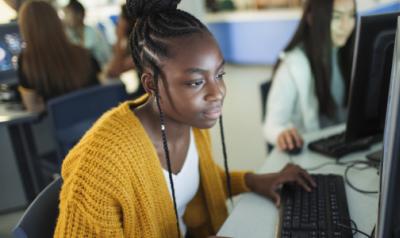 Young professional on a computer in a classroom