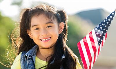 Preschool aged girl holding an American flag