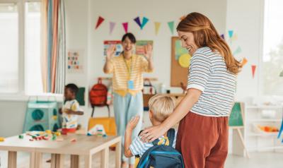 A mother introducing her child to their teacher