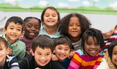Children posing for a picture in a classroom