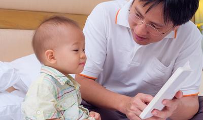 Father reading to baby