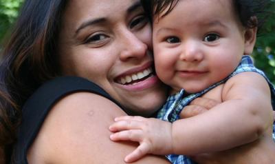 Mother hugging baby