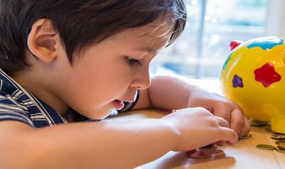 Young child counting with coins