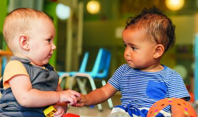 Infants holding hands