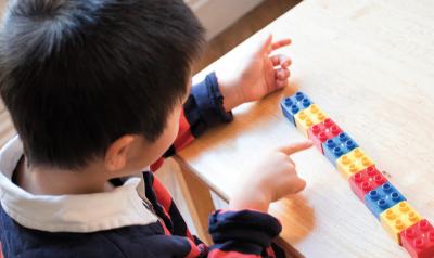 Boy counting his lego blocks