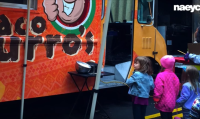 Preschoolers standing at taco truck