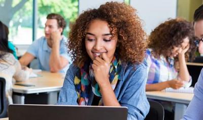 Woman at a computer looking at the screen