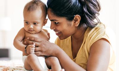 Mother holding infant daughter