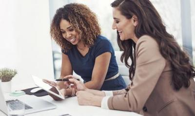 Two women looking at a laptop computer