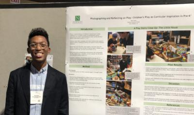 Ron Grady standing next to a poster board he presented at a conference.