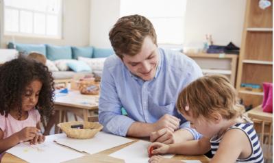 A teacher instructing young children in a classroom.