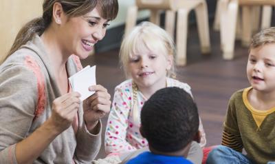 A teacher showing children a picture