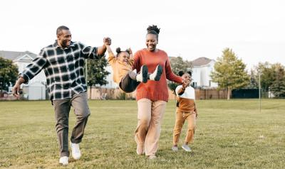 A happy family playing outside.