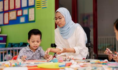 a teacher making crafts with a child