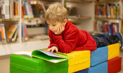 a child reading a book in a classroom