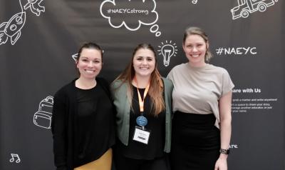 Three Public Policy Forum attendees posing in front a the NAEYC background