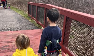 Two children holding hands walking