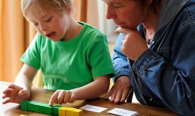 Child with disability playing with blocks