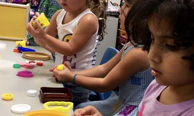 Children in a classroom playing with playdough