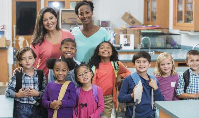 Two teachers and a group of early primary students