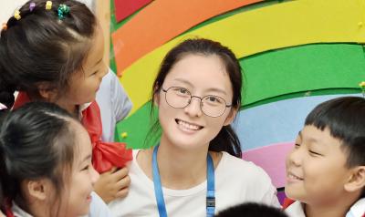 Teacher in a classroom with 3 young children