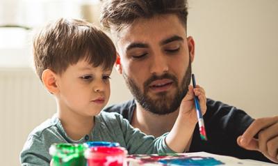 a parent painting with a child