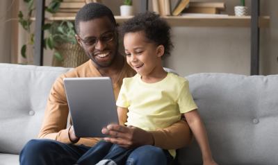 a parent with a child on  a tablet