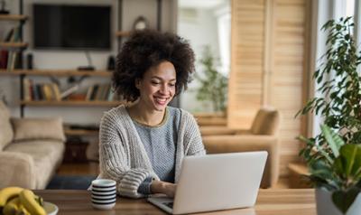 woman on a laptop smiling