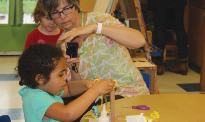 A teacher documenting a child's explorations.