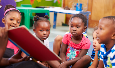 a group of children being read to