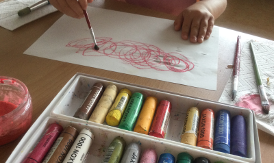 a child using art supplies and paint