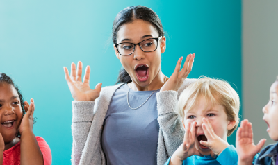 A teacher chants with children.