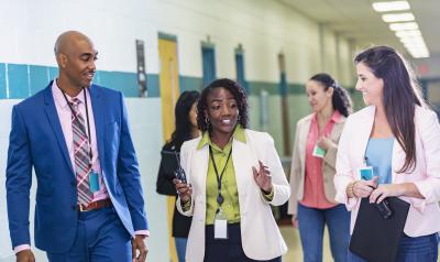 Teacher having a conversation in a school hallway