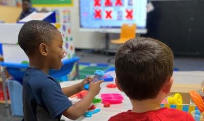 Two children working on a project in their classroom